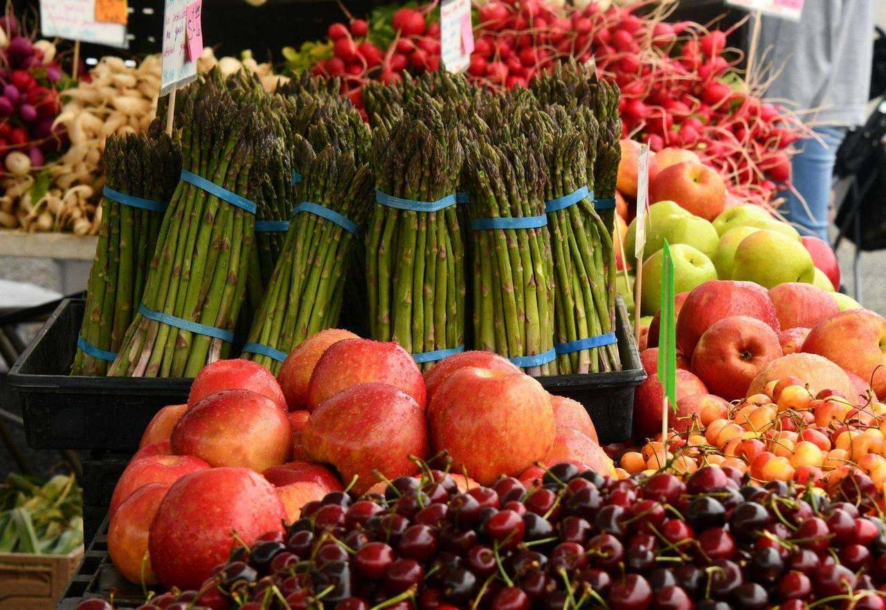Farmers market stand with asparagus, radishes and cherries