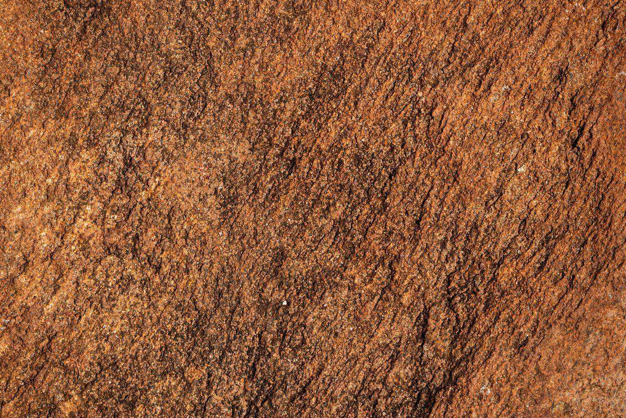 Close-up rust colored cracked earth texture