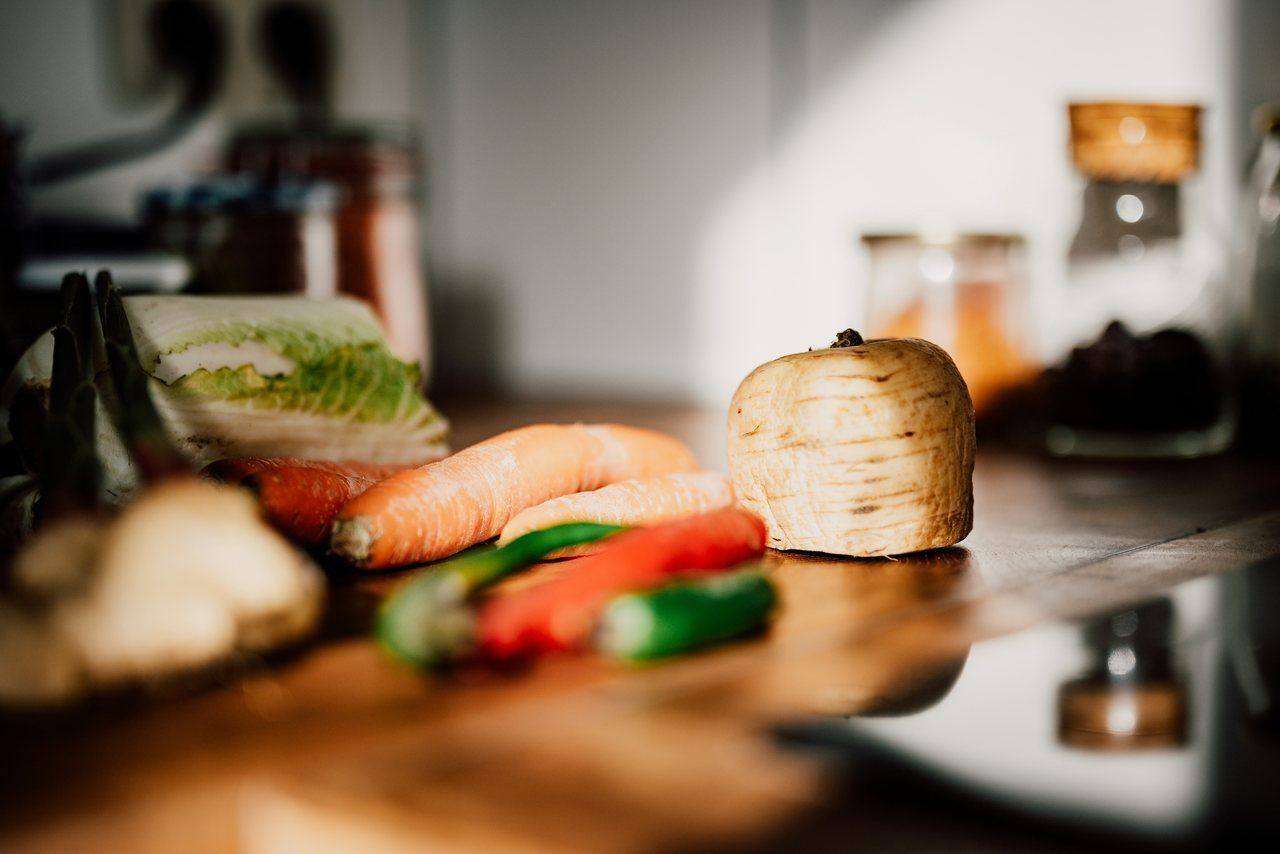 Vegetables and herbs on wooden kitchen counter