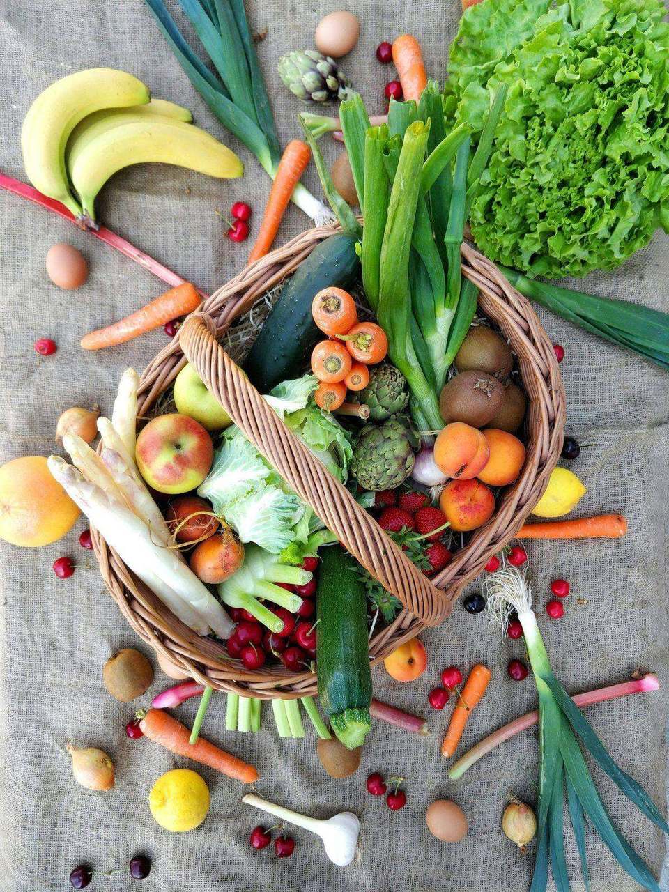 Large overhead harvest basket with varied fruit and vegetables