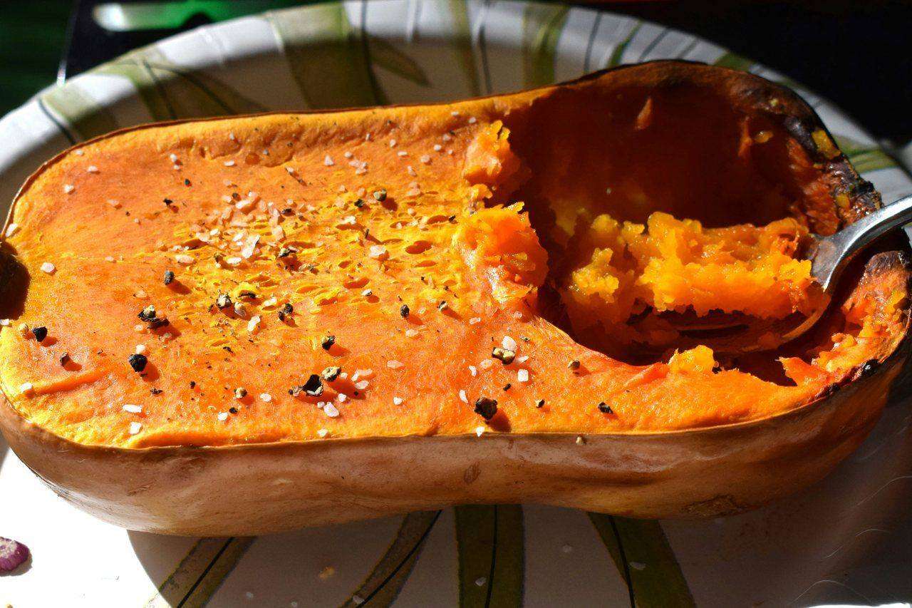 Roasted butternut squash half seasoned on plate