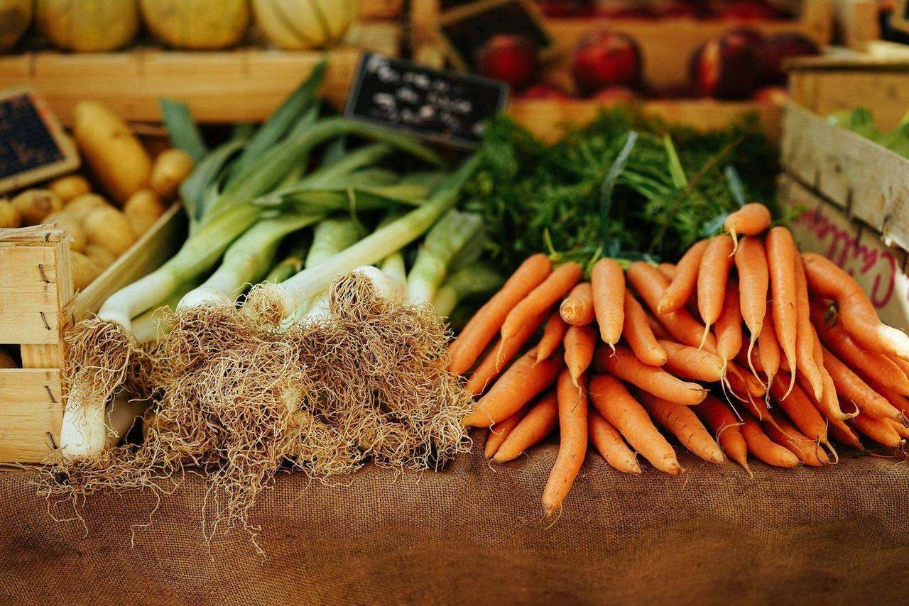 Farm stand display of potatoes leeks and carrots