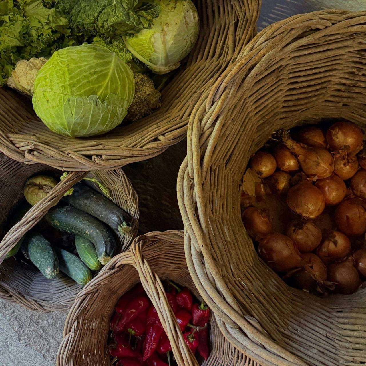 Overhead view of woven baskets full of fresh vegetables