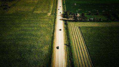 Aerial view of rural road cutting through farmland