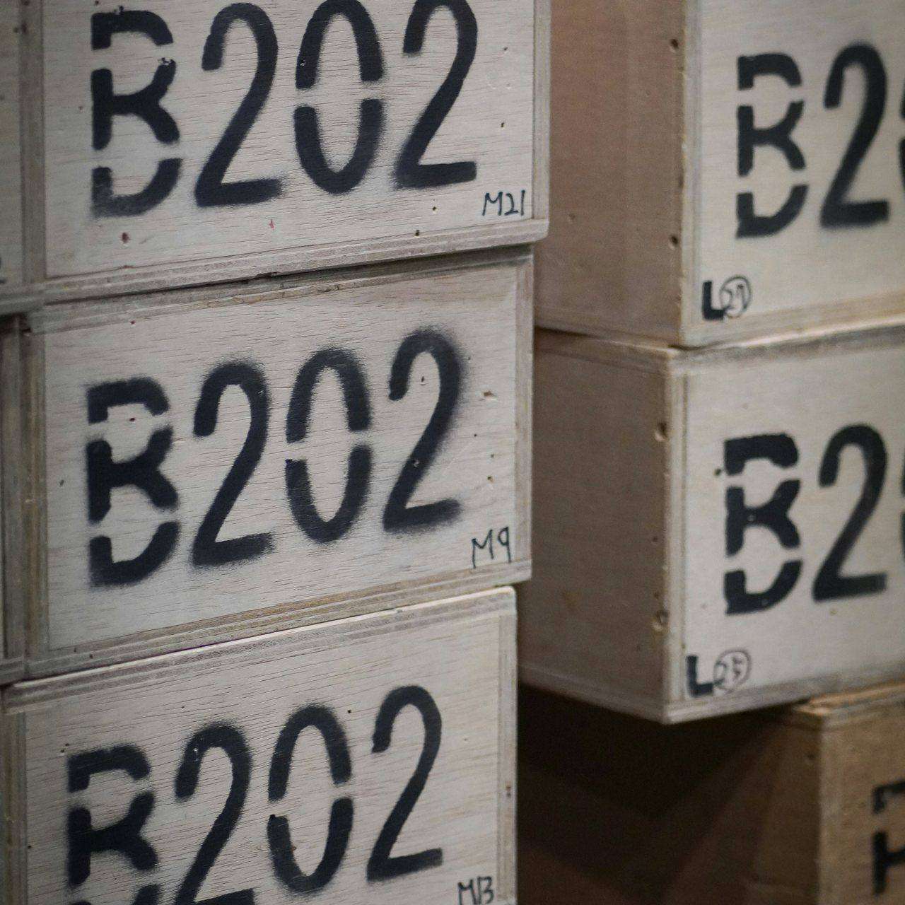 Stacked wooden crates stenciled with code B202