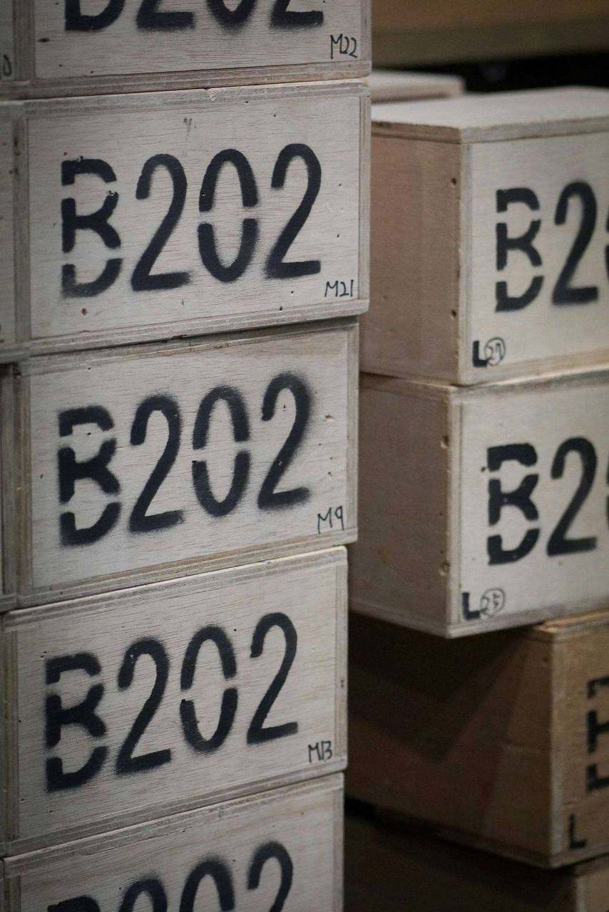 Stacked wooden crates stenciled with code B202